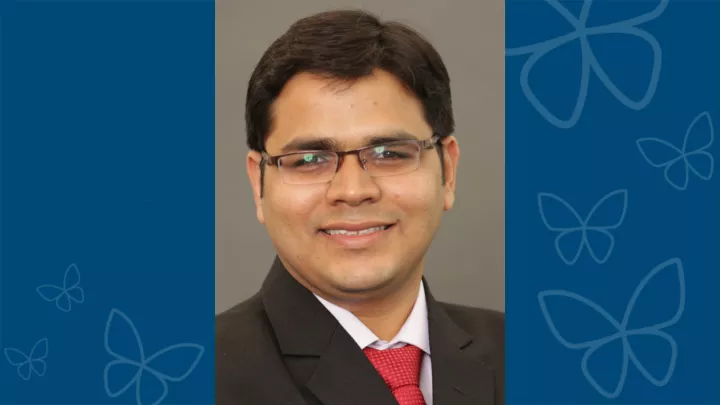 Professional headshot of Jashdeep Bhattacharjee, PhD against blue letterbox background