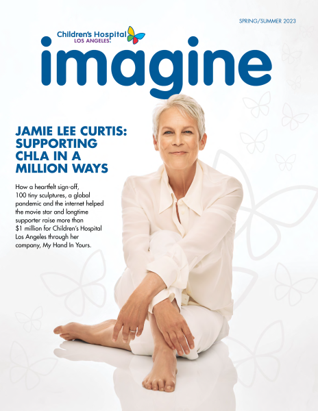 Actress Jamie Lee Curtis, a woman with light skin tone and frosty hair, sits cross-legged as the cover image of Imagine magazine