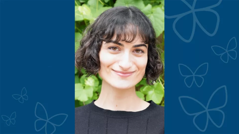 Professional headshot of Kayla Stepanian against a blue background with CHLA butterfly logo