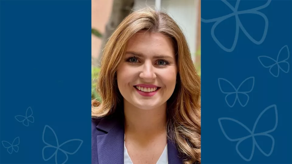 Professional headshot of MaKayla O’Guinn, DO, against a blue background with CHLA butterfly logo