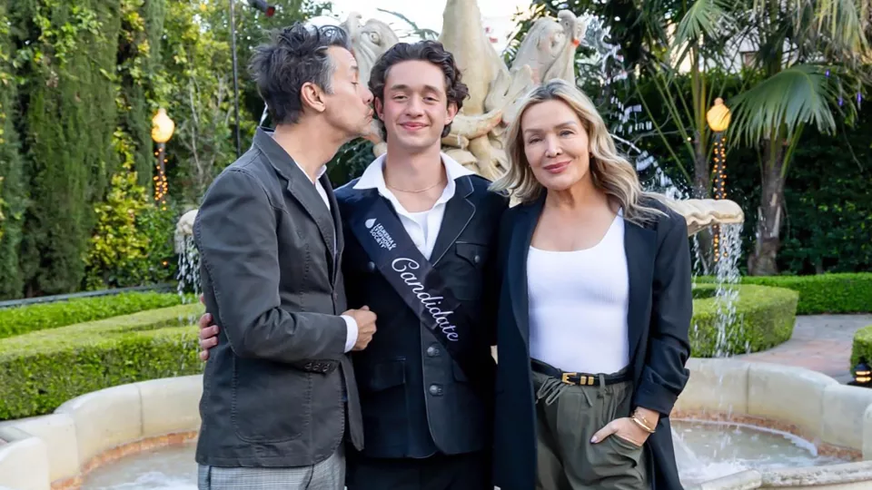 17-year-old Hunter stands in between his mom and dad wearing a Leukemia and Lymphoma society sash. 