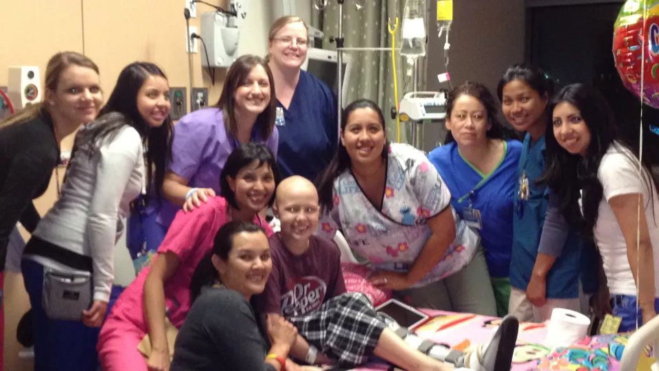 Young Kate is surrounded by her care staff on 4 West at CHLA.