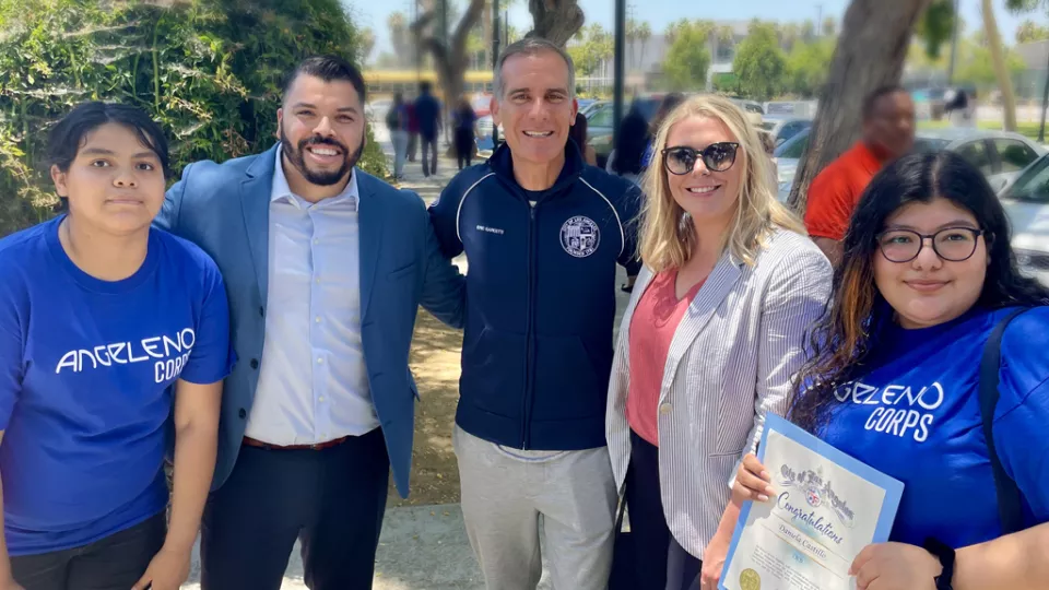 Los Angeles Mayor Eric Garcetti smiles as he stands with members of Angeleno Corps