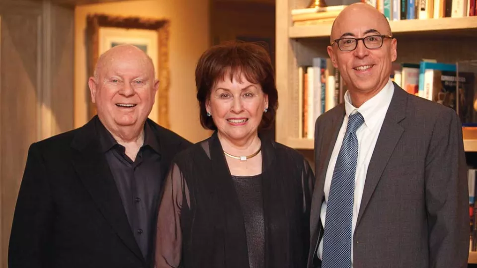 Herb and Beverly Gelfand stand next to Dr. Alan S. Wayne