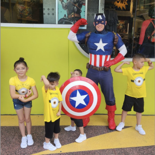 Nano holds Captain America's shield with three of his siblings at Disney World.