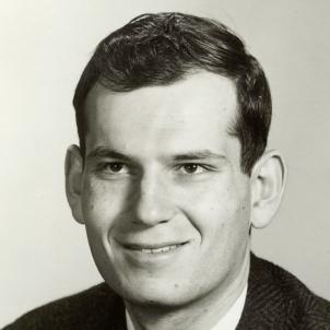 Black-and-white photo of man with dark hair and light complexion wearing a tie