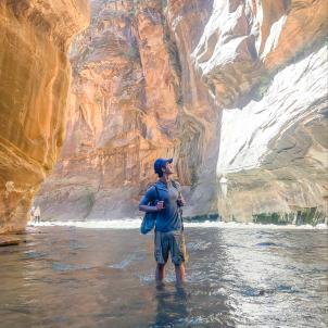 17-year-old Hunter stands in the river in "The Narrows" slot canyon at Zion National Park.