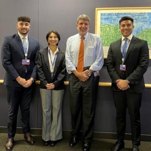 CHLA CEO Paul Viviano stands with three young professionals in business attire