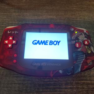 A red Game Boy advance with a custom red shell, metal buttons, LCD screen,rechargeable battery, and amplified audio. 