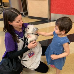 Ariana with therapist and therapy dog