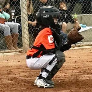 Josh playing catcher during a little league baseball game