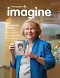 Cover of Children's Hospital Los Angeles Winter 2024 edition of Imagine magazine that shows a smiling woman with light skin tone and short blonde hair holding a black and white picture of herself as a nurse