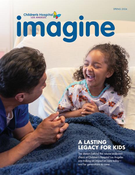 Cover image of Imagine Magazine Spring 2024 edition showing a young patient with dark skin tone and curly dark hair laughing with a male healthcare provider
