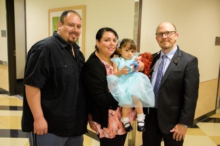 Angelique Garcia and her parents smiling and posing next to Dr. Pruitz.